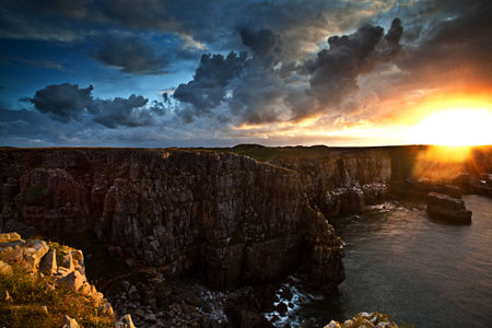 First rays of light on Welsh coastline boasting vibrant hues
