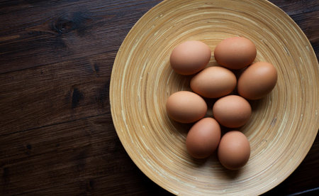 A selection of organic, brown eggs about to cooked at breakfast.の写真素材