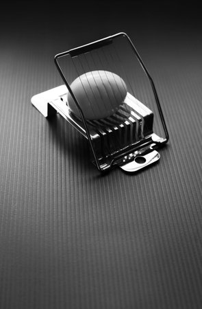 Freshly boiled egg about to sliced with wire cutter for lunchの写真素材