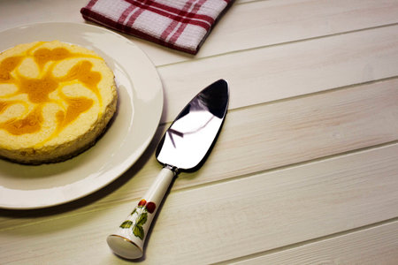 Newly made Lemon Cheese Cake placed on kitchen table ready to serveの写真素材