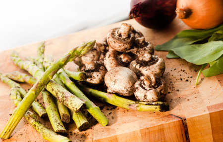 Fresh organic vegetables on cutting board just before being washed.の写真素材
