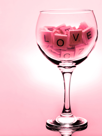 An large wine glass with the words love  with red color castの写真素材
