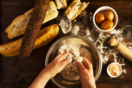 Baker making fresh organic bread in kitchen.