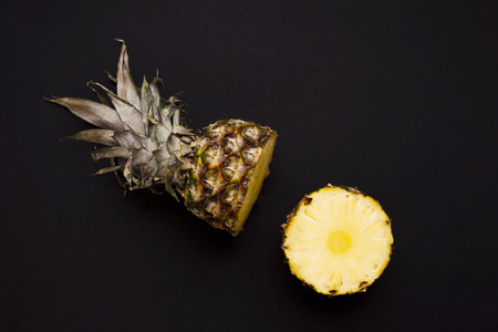 Pineapple. Shot sliced in half to show inner fruit