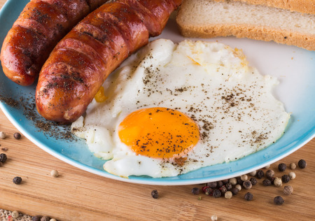 English breakfast with sausage and fried eggの写真素材