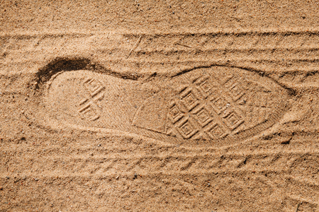 Footprint tread shoes and tires on the country road sandの写真素材