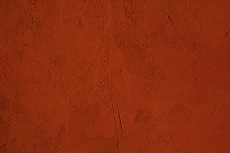 Cement wall background painted orange with textureの写真素材