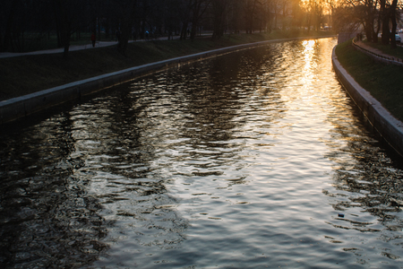 wonderful landscape texture of golden sunset on the surface of the river channelの写真素材