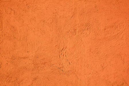 Cement wall background painted orange with textureの写真素材