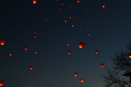 A large group of chinese flying lanterns In the night skyの写真素材