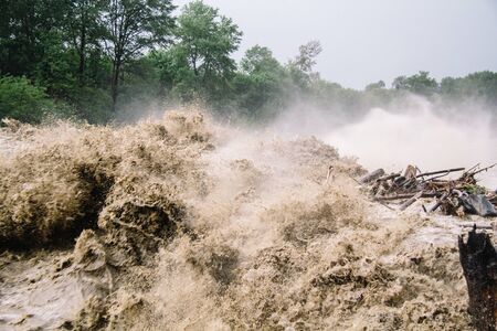Strong flow of water at a hydroelectric dam. The dam of a mountain river after heavy rains in Adygeaの写真素材