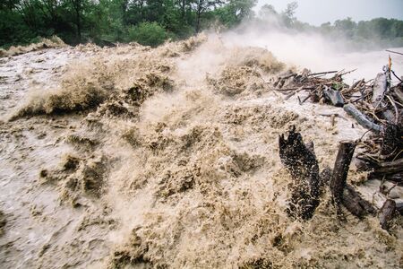 Strong flow of water at a hydroelectric dam. The dam of a mountain river after heavy rains in Adygeaの写真素材