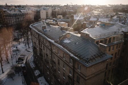 Amazing sunset on the roofs of the old district of St. Petersburg. In winter seasonの写真素材