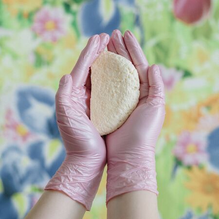 Freshly made homemade cheese in female hands in pink nitrile gloves. Fresh panir or Adyghe cheese...