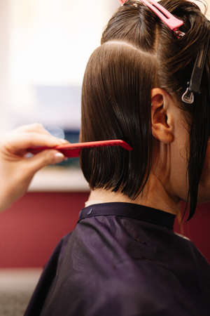 Professional hairdresser woman with comb and scissors in her hands.の写真素材
