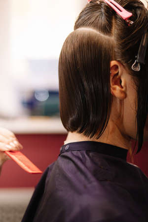 Professional hairdresser woman with comb and scissors in her hands.の写真素材