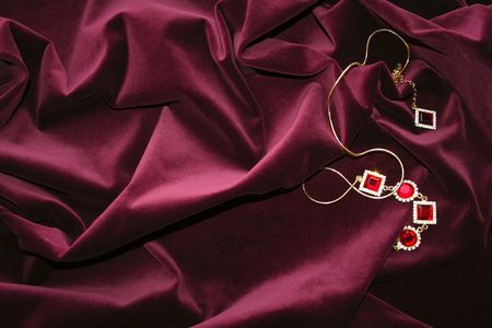 Jevel on pleated cherry-coloured velvetの写真素材