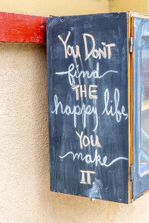 Chalkboard with the words You don't find the happy life, you make itの写真素材