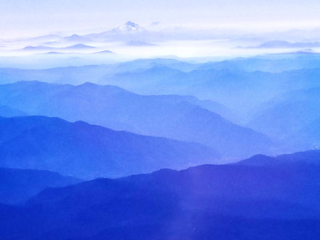 Mountains in the clouds, view from the plane. Digital painting.