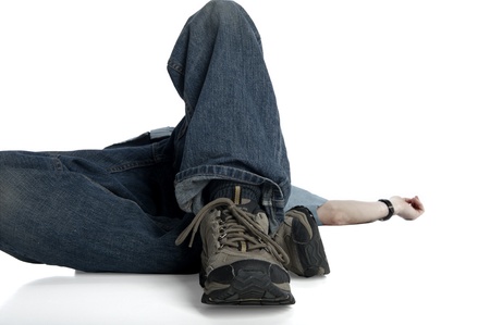 man lying on his back, focus on feet near the camera 