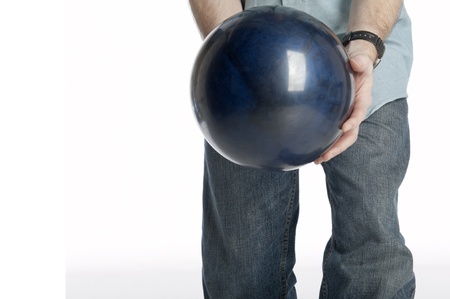 man holds a dark blue marbled bowling ball isolated on whiteの写真素材