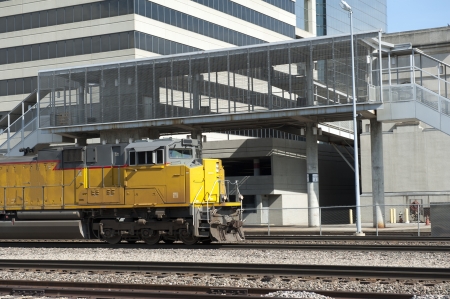 Train engine passes an office building and station stopのeditorial素材