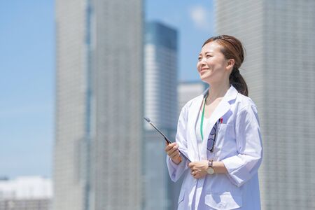 a woman in a white coatの写真素材