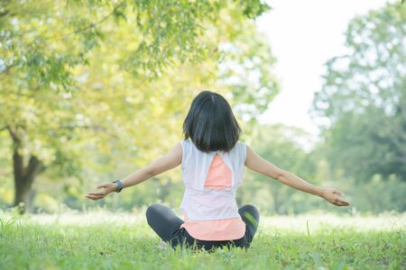 A woman takes a deep breath during exerciseの写真素材