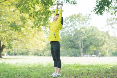 A woman takes a deep breath during exerciseの写真素材