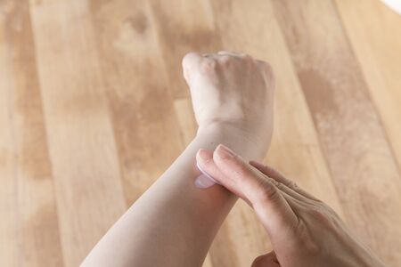 Applying sunscreen to your armの写真素材