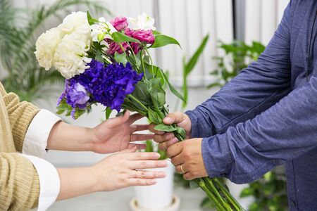 Husband sending flowers to wifeの写真素材