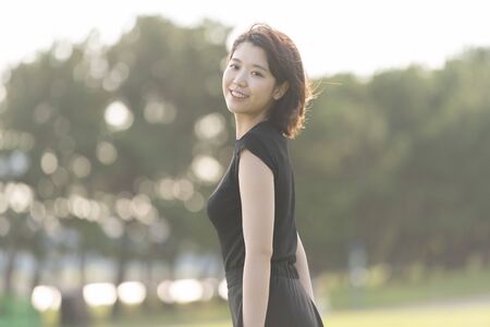 A young woman walking in the parkの写真素材