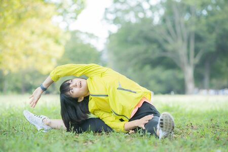 a woman exercising in the park