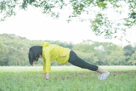 a woman exercising in the parkの写真素材