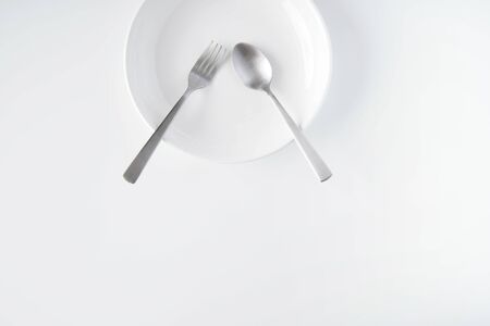 White dish, fork, spoon