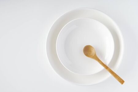 White plate, wooden spoonの写真素材