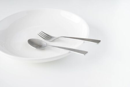 White dish, fork, spoonの写真素材