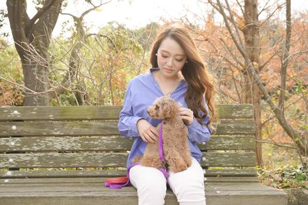 A woman walking in the park with her pet