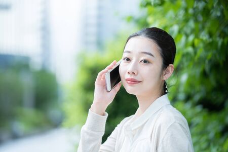 Young female business person using a smartphoneの写真素材