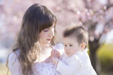 Baby, Mother and Cherry Treeの写真素材