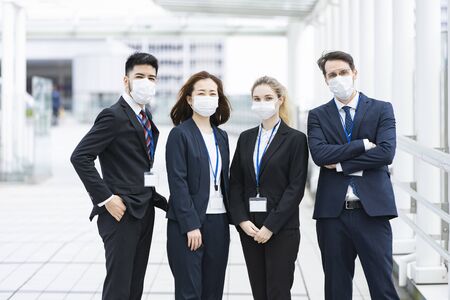 Team of businessmen wearing masksの写真素材