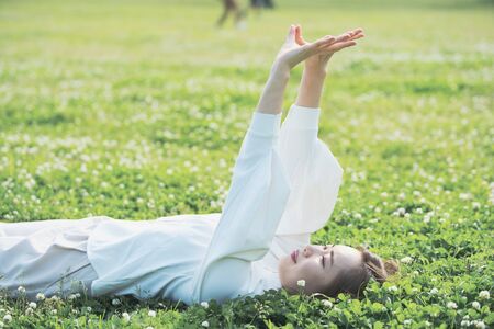 Asian young woman showing a relaxed expression on the meadow