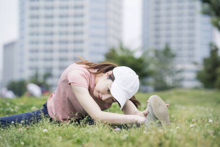 Asian young woman wearing sportswear and exercising in the parkの写真素材