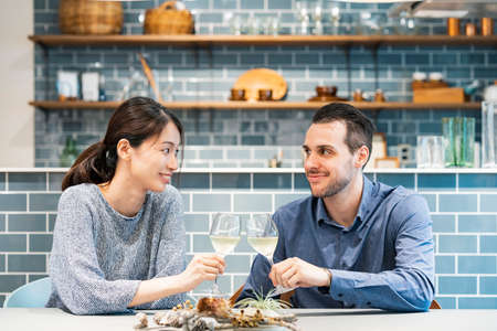 Image photograph of man and woman toasting at dining kitchen