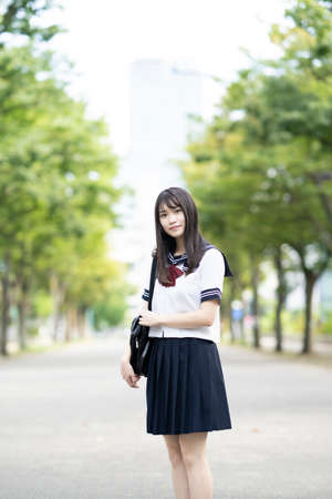 female asian high school student with a calm look outdoorsの写真素材