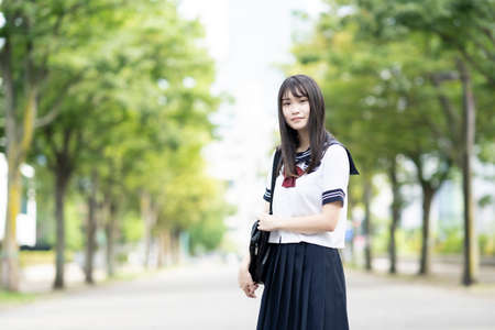 female asian high school student with a calm look outdoorsの写真素材