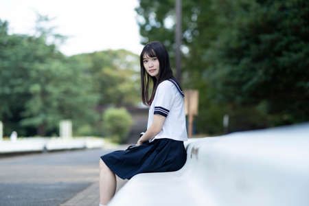 female asian high school student with a calm look outdoorsの写真素材