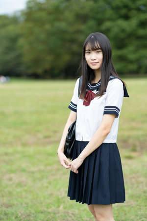 female asian high school student with a calm look outdoorsの写真素材