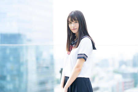 female asian high school student with a calm look outdoorsの写真素材