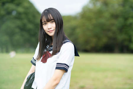 female asian high school student with a calm look outdoorsの写真素材